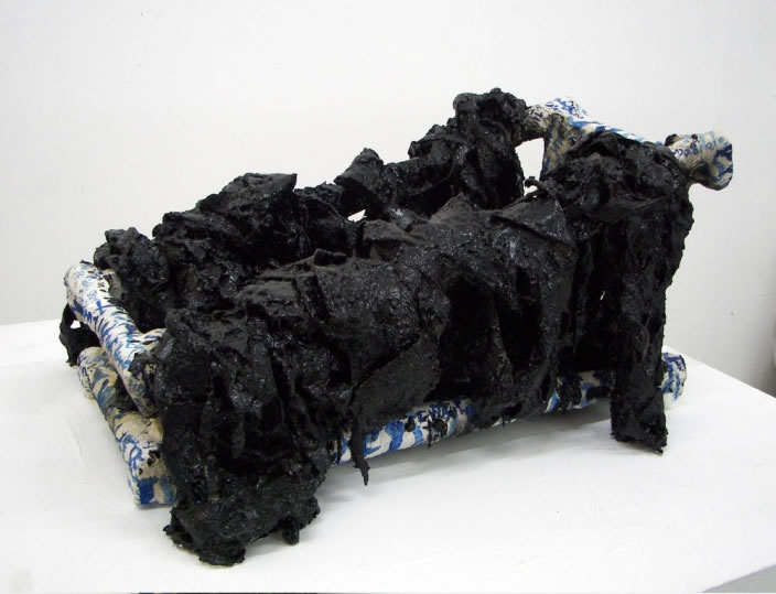 I was here, 2009, Sculpture in mixed media (asphalt, wood, paint, feathers...), 66 x 32 x 35 cm